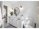 Bright bathroom with shiplap wall, patterned tile floor, and dark fixtures at 4100 3Rd S Ave, St Petersburg, FL 33711