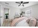 Bedroom with decor, gray walls, and wood floors leads to hallway with plants and decor at 4100 3Rd S Ave, St Petersburg, FL 33711