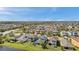 Breathtaking aerial perspective of a well-planned community with charming homes and a tranquil lake at 4522 Tramanto Ln, Wesley Chapel, FL 33543