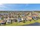 Expansive aerial view showcasing a diverse neighborhood with a mix of housing styles and scenic water features at 4522 Tramanto Ln, Wesley Chapel, FL 33543