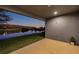 Spacious back patio with a serene view of the lake at dusk, perfect for outdoor relaxation and entertaining at 4522 Tramanto Ln, Wesley Chapel, FL 33543