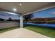 This covered patio offers a tranquil view of the adjacent lake, a perfect setting to unwind and enjoy the outdoors at 4522 Tramanto Ln, Wesley Chapel, FL 33543