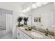 Bathroom with a double sink vanity, granite countertops, and a shower with a curtain at 4522 Tramanto Ln, Wesley Chapel, FL 33543