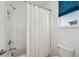 Bathroom featuring a shower/tub combination, white tile, and bright natural light at 4522 Tramanto Ln, Wesley Chapel, FL 33543