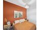 Cozy bedroom with an accent wall, woven lighting, and cactus-themed artwork at 4522 Tramanto Ln, Wesley Chapel, FL 33543