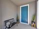 Cozy front porch with a bench, decorative pillows, potted cacti, and a bright blue front door at 4522 Tramanto Ln, Wesley Chapel, FL 33543