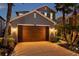 Exterior elevation of a two-story home with a two-car garage and manicured, landscaped yard at 4522 Tramanto Ln, Wesley Chapel, FL 33543