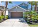 Beautiful two-story home featuring blue shutters, lush landscaping, a two-car garage, and well-kept lawn at 4522 Tramanto Ln, Wesley Chapel, FL 33543