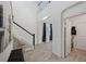 Bright foyer featuring a staircase with elegant white railings and wood-look tile flooring at 4522 Tramanto Ln, Wesley Chapel, FL 33543