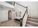 Foyer featuring a staircase with modern black railings and wood-look tile flooring at 4522 Tramanto Ln, Wesley Chapel, FL 33543