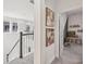 Upstairs hallway with neutral walls, framed art, and a view into an adjacent bedroom at 4522 Tramanto Ln, Wesley Chapel, FL 33543