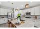 Well-lit kitchen island featuring a large sink, granite countertop, and seating for casual dining at 4522 Tramanto Ln, Wesley Chapel, FL 33543