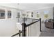 Bright loft area with multiple windows, neutral carpet, and a modern railing at 4522 Tramanto Ln, Wesley Chapel, FL 33543