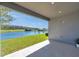 Covered patio with scenic views of the surrounding pond and lush landscaping at 4522 Tramanto Ln, Wesley Chapel, FL 33543