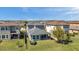 The home's rear exterior features a covered patio, windows, and well-maintained lawn and landscaping at 4522 Tramanto Ln, Wesley Chapel, FL 33543