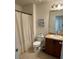 Bathroom with tile flooring, dark cabinets, shower, and new fixtures at 4632 Chatterton Way, Riverview, FL 33578