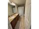 Bathroom features a double sink vanity with granite countertop and tub with shower at 4632 Chatterton Way, Riverview, FL 33578