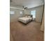 Neutral primary bedroom with ceiling fan, carpeted floors, and natural light at 4632 Chatterton Way, Riverview, FL 33578