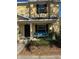 Charming two-story townhouse with covered front porch and seating area at 4632 Chatterton Way, Riverview, FL 33578