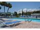 Relaxing pool area with lounge chairs, perfect for enjoying sunny days by the clear water with palm trees in the background at 4851 W Gandy Blvd # B5L19, Tampa, FL 33611