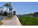 Picturesque waterfront view with a paved walkway lined with palm trees, offering serene and scenic enjoyment at 4851 W Gandy Blvd # B5L19, Tampa, FL 33611