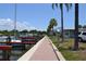 Picturesque waterfront view featuring a boat dock, palm trees, and a scenic walkway, creating an inviting coastal atmosphere at 4851 W Gandy Blvd # B5L19, Tampa, FL 33611