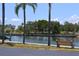 Scenic waterfront area with palm trees, benches, and docks, perfect for relaxation and enjoying the tranquil water view at 4851 W Gandy Blvd # B5L19, Tampa, FL 33611