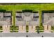 Aerial view of townhomes showcasing roof designs, landscaping, and street layout at 4896 San Martino Dr, Wesley Chapel, FL 33543
