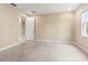 Spacious bedroom with carpet flooring and ample natural light from a window at 4896 San Martino Dr, Wesley Chapel, FL 33543