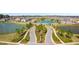 Aerial view of community entrance with lush landscaping and water feature at 4896 San Martino Dr, Wesley Chapel, FL 33543