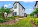 Modern two-story townhouse showcasing a two-car garage and beautifully landscaped yard at 4896 San Martino Dr, Wesley Chapel, FL 33543