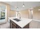 Bright kitchen with a central island featuring a stainless steel sink and modern faucet at 4896 San Martino Dr, Wesley Chapel, FL 33543