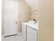 Bright laundry room featuring tile flooring and modern washer and dryer at 4896 San Martino Dr, Wesley Chapel, FL 33543