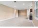 Bright, open-concept living space with tile floors and access to the kitchen area at 4896 San Martino Dr, Wesley Chapel, FL 33543