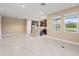Open-concept living area features tile flooring, modern lighting, and scenic views from its well-placed windows at 4896 San Martino Dr, Wesley Chapel, FL 33543