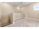 Cozy loft with neutral carpeting, trimmed half-wall, and ample natural light from the window at 4896 San Martino Dr, Wesley Chapel, FL 33543