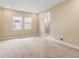 Spacious main bedroom with neutral carpeting, ample natural light, and an en-suite bathroom at 4896 San Martino Dr, Wesley Chapel, FL 33543