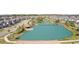 Scenic aerial view of the community pond with a gazebo at 4896 San Martino Dr, Wesley Chapel, FL 33543