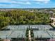 Aerial view shows community tennis courts and well maintained landscaping at 4896 San Martino Dr, Wesley Chapel, FL 33543