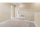 Upstairs landing area with neutral carpeting and paint tones, offering a view of the hallway at 4896 San Martino Dr, Wesley Chapel, FL 33543