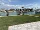 Canal-front home with manicured lawn and private boat dock, offering direct access to waterways at 525 Crystal Dr, Madeira Beach, FL 33708