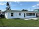 Inviting backyard with a well-manicured lawn and stylish patio, perfect for outdoor relaxation and entertainment at 525 Crystal Dr, Madeira Beach, FL 33708