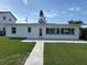 Charming single-story home featuring a well-manicured lawn and a quaint tiled patio at 525 Crystal Dr, Madeira Beach, FL 33708
