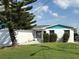Charming single-story home with a well-maintained lawn, mature tree, and a cozy, inviting facade at 525 Crystal Dr, Madeira Beach, FL 33708