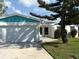 Pleasant home exterior featuring a spacious garage, well-maintained lawn, and freshly painted accents at 525 Crystal Dr, Madeira Beach, FL 33708