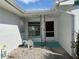 Charming front entrance with decorative metalwork, a white brick facade, and whimsical statuary at 525 Crystal Dr, Madeira Beach, FL 33708