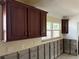 Classic kitchen featuring wood cabinets, a window, and unfinished drywall at 525 Crystal Dr, Madeira Beach, FL 33708