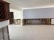 Open concept living room area featuring white tile floors and views of other rooms needing renovation at 525 Crystal Dr, Madeira Beach, FL 33708