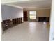 Spacious living room featuring tile flooring, a large window, and unfinished drywall at 525 Crystal Dr, Madeira Beach, FL 33708