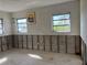 Room needing renovation featuring concrete floors, exposed walls, windows, and signs of water damage at 525 Crystal Dr, Madeira Beach, FL 33708